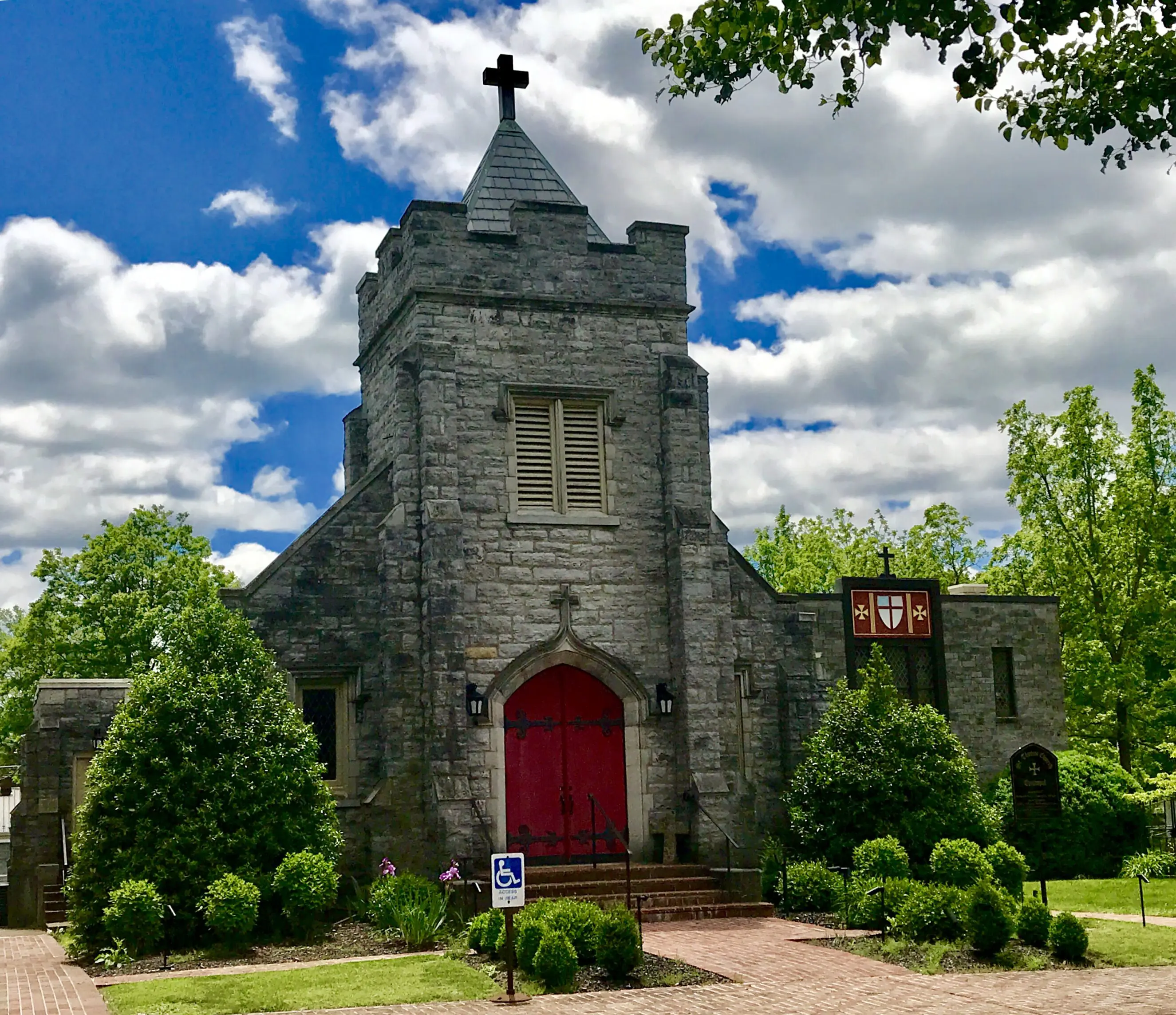 124 East Main St St. Thomas Episcopal Church Stone St. Thomas Episcopal Church with red doors under blue sky and
