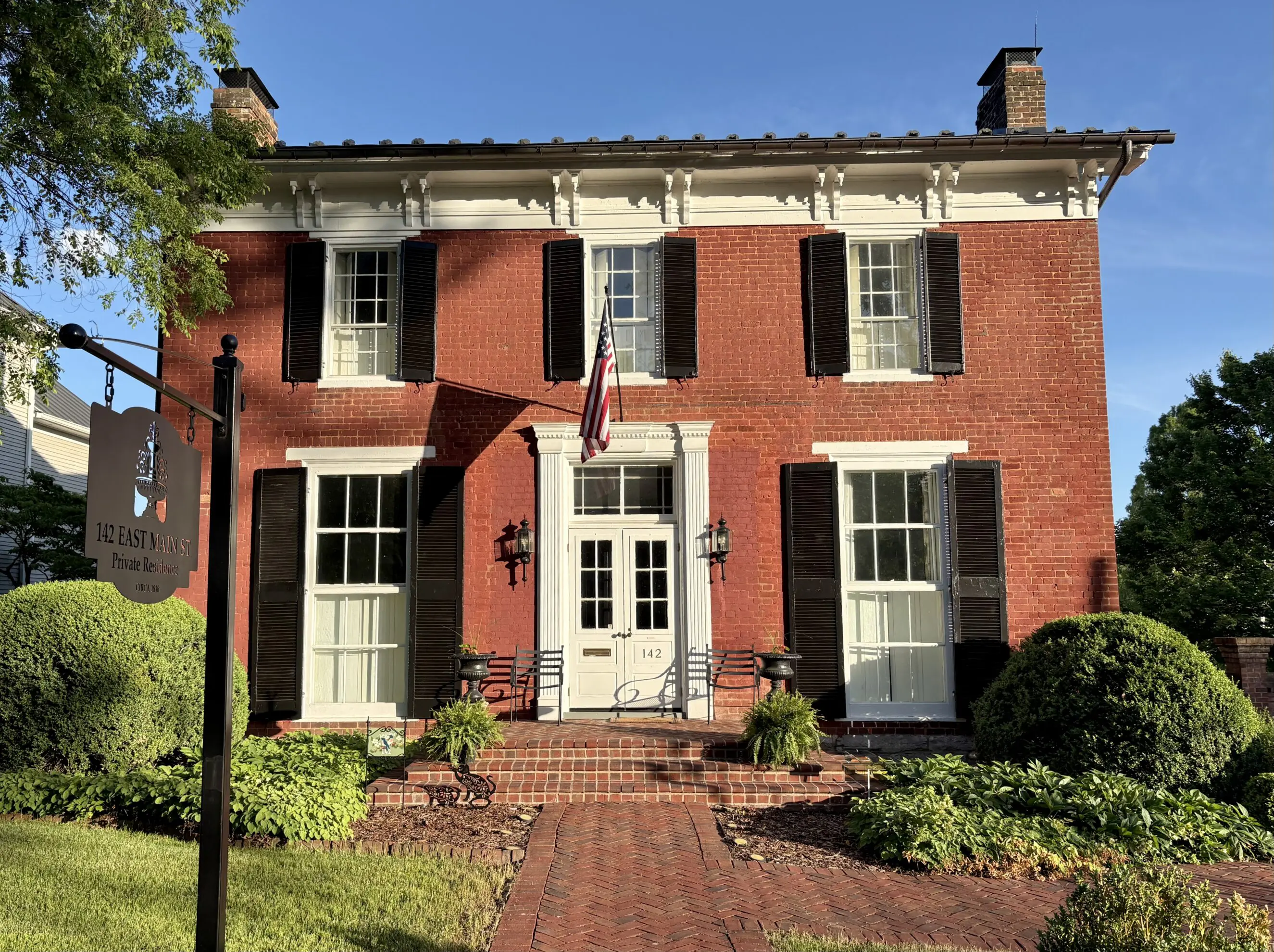 142 E. Main St. Lundy House Brick colonial house 142 East Main Street with black shutters, white trim,