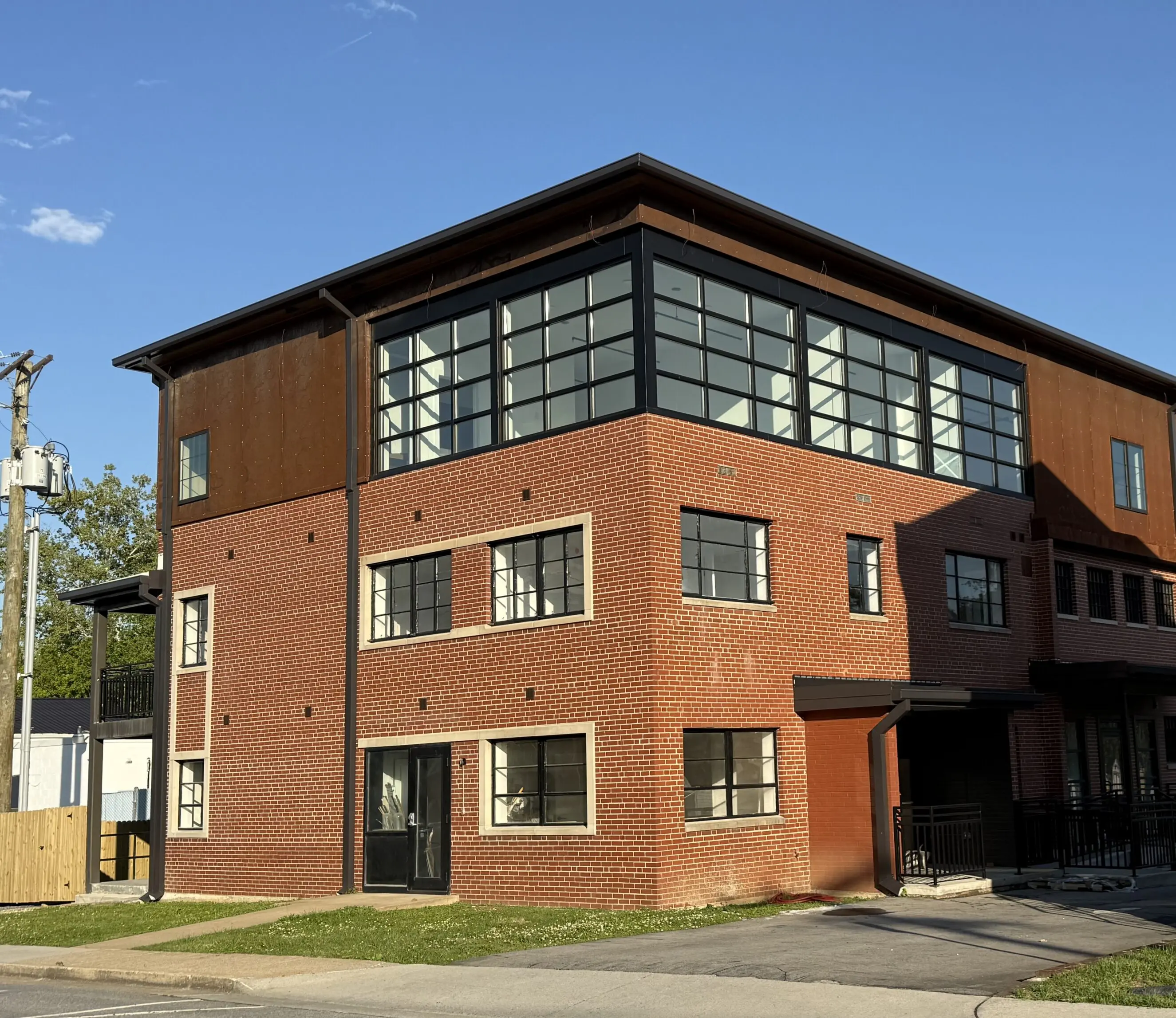 216 Park St. The Klink Three-story brick and metal building with large black-framed windows at 216 Park