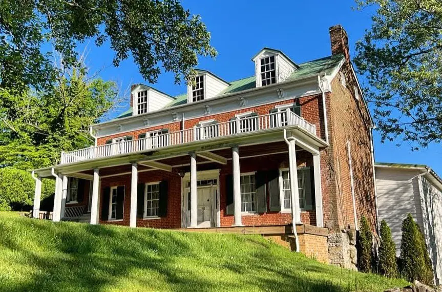 702 Colonial Road, Retirement at the Muster Grounds Historic two-story brick house at 702 Colonial Road with green shutters and